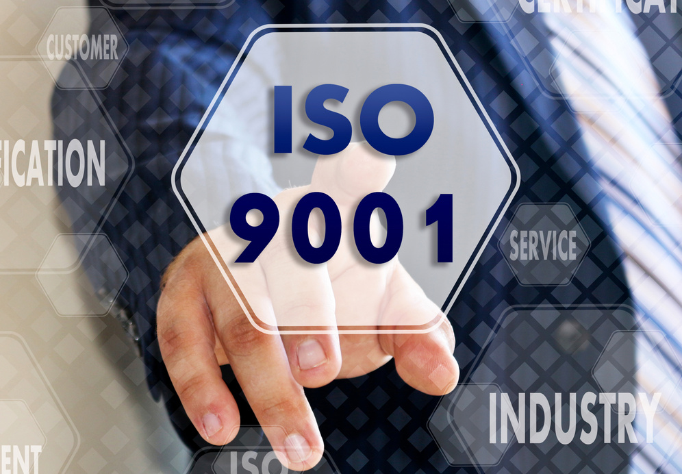 The businessman chooses ISO 9001,  presses a button on the touch screen